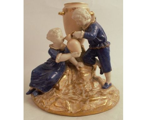 A Royal Worcester figure group, of a girl and boy in mottled blue with the girl drinking from a jug, with blush ivory urn and