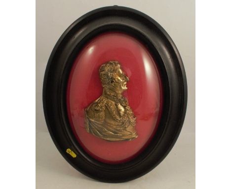 A 19th century relief gilt metal portrait plaque, of the Duke of Wellington, in an oval frame, overall height 16.5ins