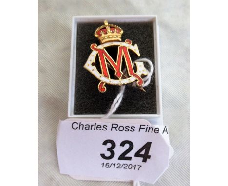 An enamel brooch of Royal interest, depicting the monogram of King George V and Queen Mary, in red and white enamel with crow
