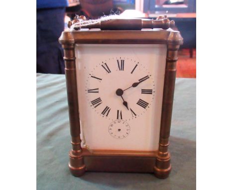 An early 20th century brass five glass carriage clock, the eight day movement striking on a bell faced by Roman and subsidiar