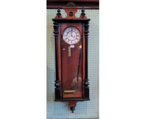 A walnut and ebonised cased Vienna wall clock, the twin train movement faced by enamel Roman dial, 124cm.