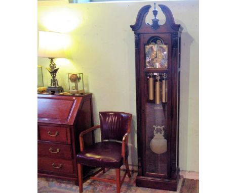 Howard Miller, a reproduction longcase clock, the German eight day movement striking on gongs, faced by moonphase and Arabic 