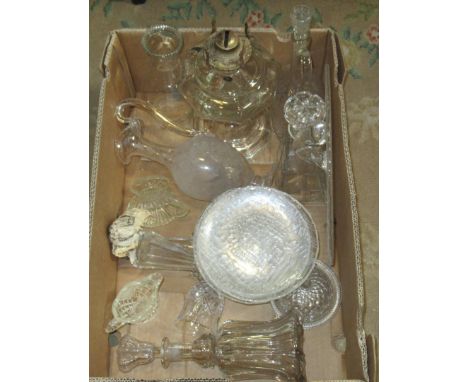 A box of largely moulded glassware, including: a paraffin lamp base, decanters, claret jugs and other similar items.