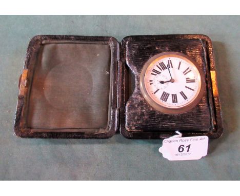 An early 20th century leather cased travelling watch,with easel support and Roman enamel dial.