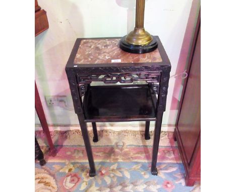 An early 20th century Chinese hardwood lamp table, the square marble inset top over blind fret carved and pierced frieze, on 