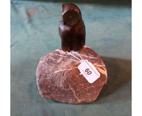 Charles Reussner (1886-1961), a brown/gilt patinated bronze of an owl perched on a veined rocky base, signed.