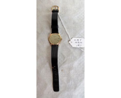 A gentleman's 14ct gold cased Baume & Mercier wristwatch, circa 1980's, on black leather bracelet.   Condition Report:  Glass