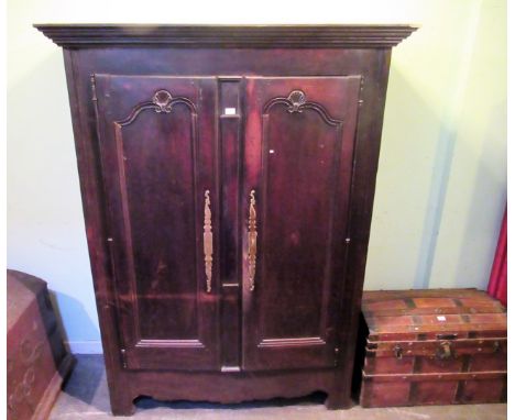 A 19th century Continental oak armoire, the moulded cornice above a pair of scallop moulded panel doors, enclosing two shelve