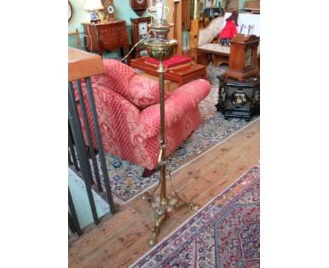 A Victorian brass paraffin standard lamp, converted for electricity.