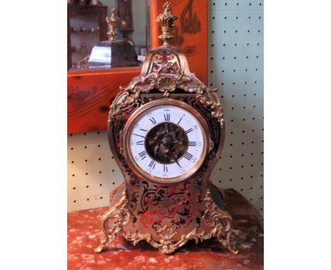 A 19th century red tortoiseshell Boulle cased mantle clock, enclosing a later movement, faced by enamel Roman dial. Condition