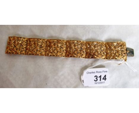 An Italian precious yellow metal panelled bracelet of curbed, pierced and engraved foliage panels, to a concealed push button