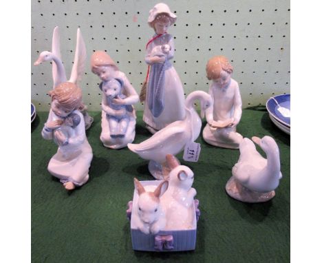 A collection of eight Nao porcelain figures, including: rabbits in a basket, girl with puppy, swan, geese and others.