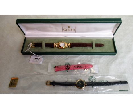Gucci. A lady's gold plated Gucci wristwatch, white enamel dial, cushion shaped case, articulated stirrup lugs, case and dial
