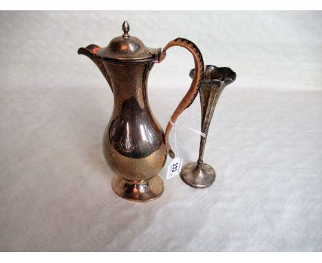 A silver hot water jug of bellied form, with cane handle, London 1901, together with a silver single stem vase by Henry Wilki