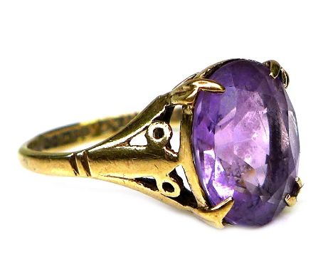 A 9ct gold and amethyst dress ring, 19th century, the oval cut stone of approximately 10 by 8mm, a/f setting missing a couple