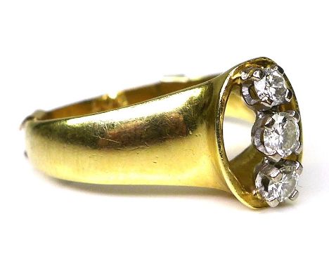 An 18ct gold and three stone diamond ring, of openwork modernist design, the three stones brilliant cut and of slightly gradu