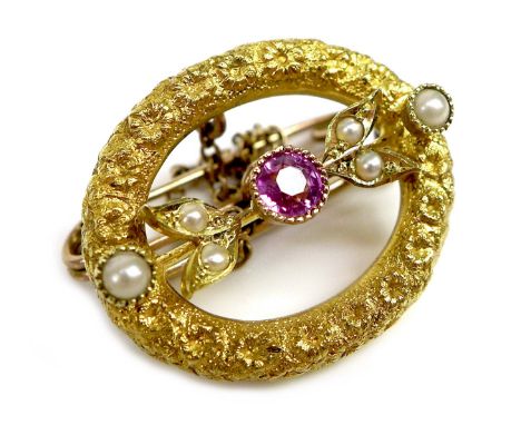 An 18ct gold, ruby and pearl brooch, of textured open oval design with central ruby of 3mm diameter, unmarked but tests as ap