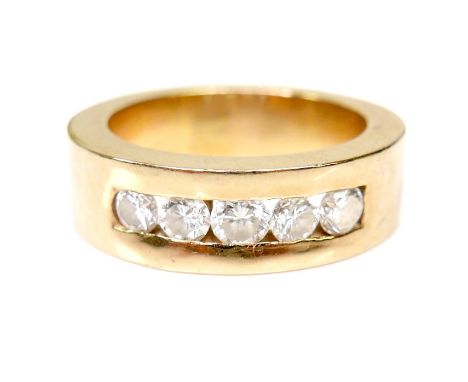 An 18ct gold and five stone diamond ring, the wide heavy band, 6mm wide, inset with brilliant cut stones each of approximatel