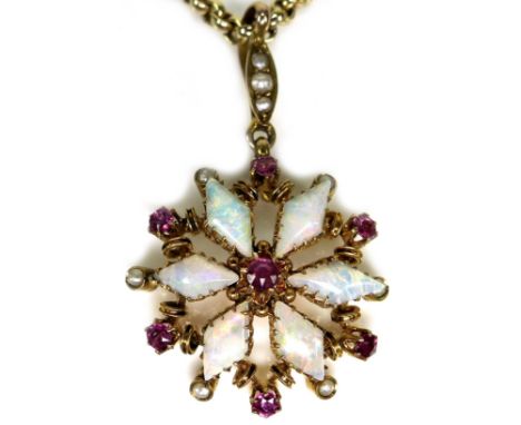 A 9ct gold ruby and opal daisy form pendant, with seven round cut rubies, 2mm diameter, six opals7mm long, interspersed by si