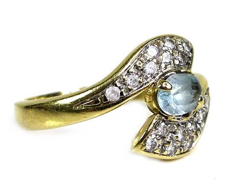 An 18ct gold and aquamarine ring, the oval cut stone of pale blue colour, approximately 6 by 4 by 3mm, scroll clasped by sixt