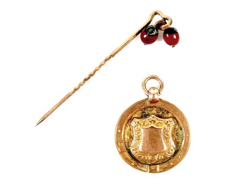 A George V 9ct gold fob pendant, cast with a shield encircled by a belt, loop attached, P&amp;M, Chester 1924, 23mm, 3.9g, to