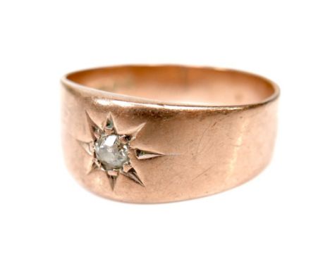 A George V rose gold diamond gypsy ring, set with an old cut circular stone of approximately 3mm / 0.1ct, London 1919, size R