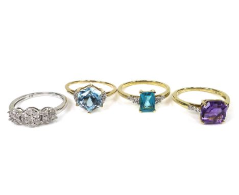 A group of 9ct gold rings by Gems TV, including a white gold example set with white stones in the form of three flowerheads, 