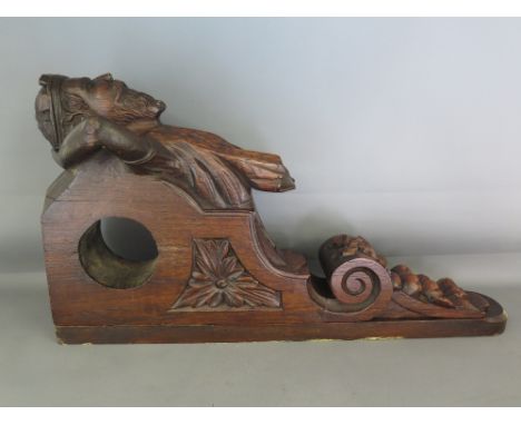 A carved oak wall bracket, the top carved with a classical crowned figure 