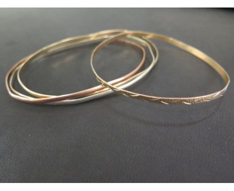A 9ct gold tri-colour interlocking bangle - Together with a tri-colour textured bangle - One hallmarked London, one obscured 