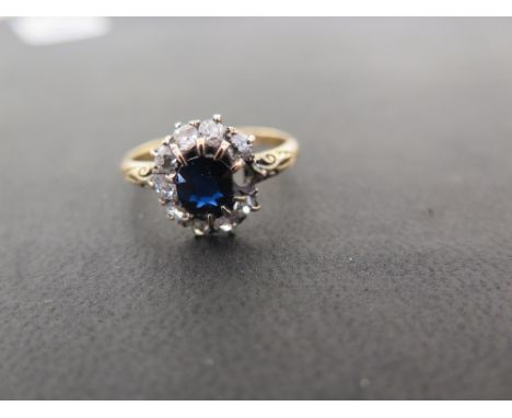 An early 20th century 18ct gold sapphire and diamond cluster ring - The oval sapphire and old-cut diamonds to the decorative 