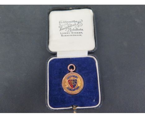 An early 20th century 9ct gold enamel 'Bowling League' medal - With reverse engraving dated 1929 - Length 3.5cms - Weight app