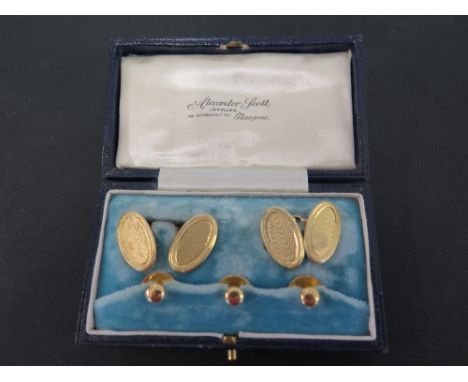 An 18ct gold cufflink and dress stud set - The textured cufflinks with three plain dress studs in an Alexander Scott, Glasgow