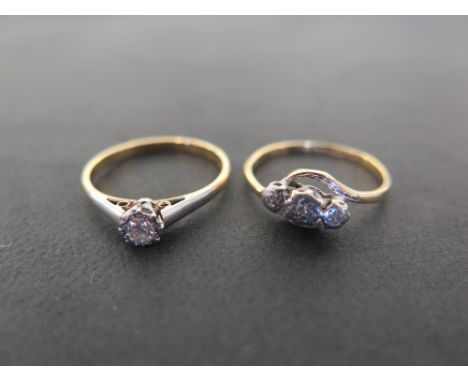 Two diamond rings - To include a single-stone and a three-stone crossover - Both stamped 18ct and plat - Ring sizes O and N -