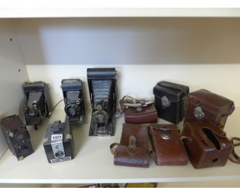 Four vintage cameras, assorted leather cases, a case with plates and Jumelle Correcta camera