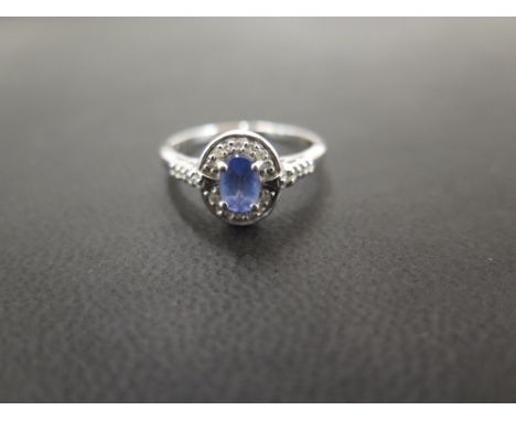 A tanzanite and diamond cluster ring - Stamped 9K - Ring size O - Weight approx 2.4gms
Condition Report: Good - With light sc