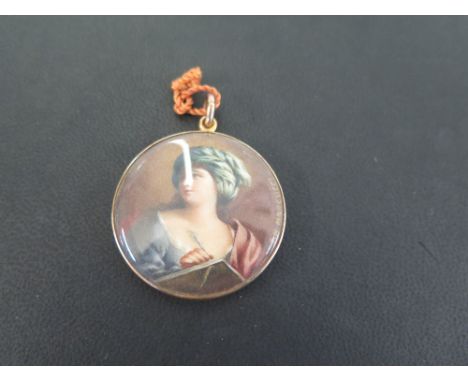 A miniature portrait pendant - The glazed circular panel depicting a lady in a head scarf writing - Signed F.M Marcucci - Tes