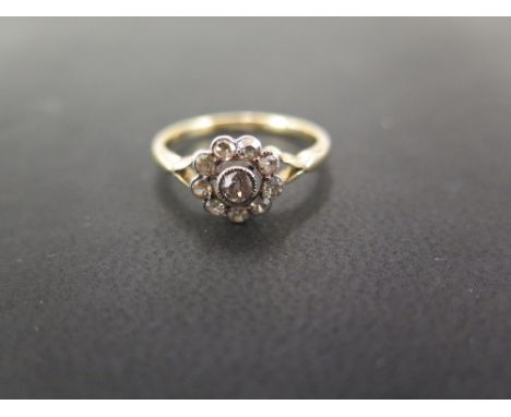 An old-cut diamond daisy cluster ring - Stamped 18ct - Ring size Q - Weight approx 2.9gms
Condition Report: Good - With light