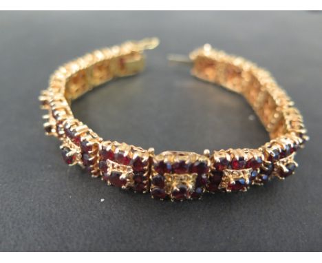 A garnet cluster panel bracelet - Stamped 8K - Length 18cms - Weight approx 41gms
Condition Report: Good to fair - With surfa