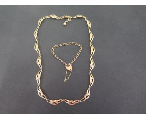 A 9ct gold fancy-link necklace - Hallmarked London - Length 46cms - Together with a 9ct gold curb-link childs bracelet - Part