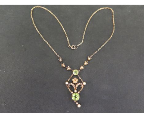 An early 20th century 15ct gold peridot and seed pearl pendant necklace - Length of pendant 4cms - Length of necklace 41cms -