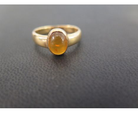 An amber cabochon single-stone ring - Stamped 18 - Ring size N 1/2 - Weight approx 5.0gms
Condition Report: Good to fair - Wi