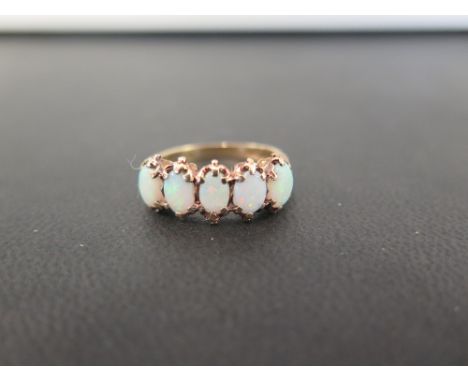 A 9ct gold opal five-stone ring - Partial hallmark - Ring size N - Weight approx 3.5gms
Condition Report: Good - With light s