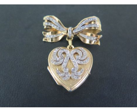 An early 20th century 9ct gold diamond brooch and pendant locket - The eight-cut diamond set bow suspending a heart-shape loc