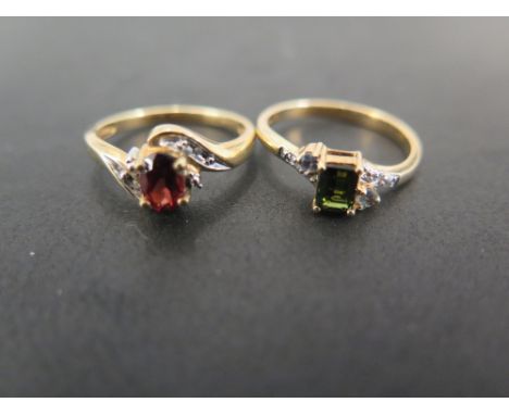 A 9ct gold garnet and diamond twist style dress ring - Ring size N 1/2 - Together with a 9ct gold tourmaline and diamond ring