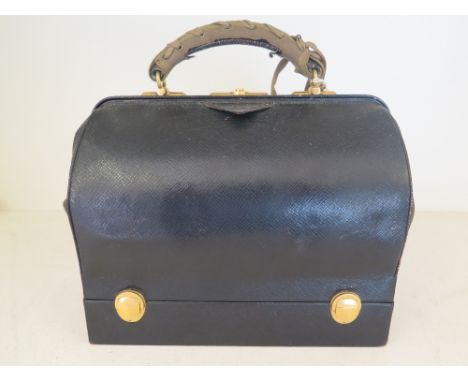 An early 20th century black leather Travelling Doctors style bag by Cartier, with fitted base compartment containing five Fre