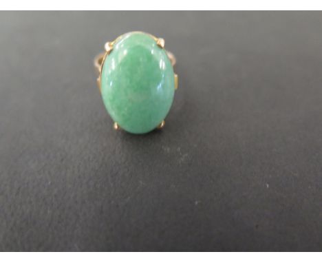A jadeite cabochon single-stone ring - Tests as higher carat gold - Ring size J - Weight approx 5.4gms
Condition Report: Good