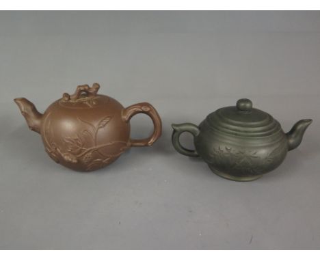 A Chinese Yixing teapot and cover with moulded tree squirrel design and another with a spinach jade shade finish decorated wi