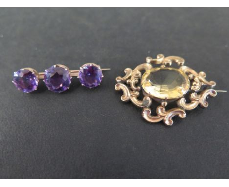 An amethyst three-stone bar brooch - Length 3.2cms - Together with a citrine brooch - Length 4cms - Both test as 9ct gold - T