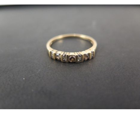 A 9ct gold diamond half-circle ring - Set with three brilliant-cut champagne diamonds with diamond double spacers - Hallmarke