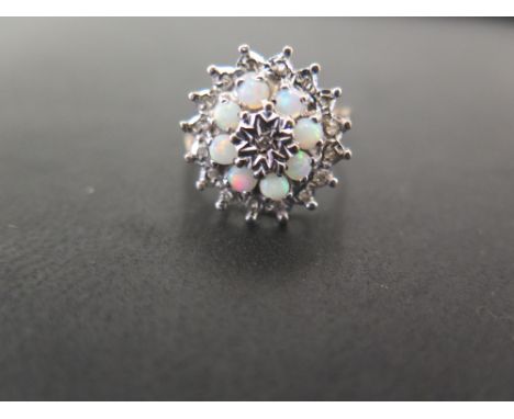 A 9ct gold opal and diamond snowflake cluster ring - Hallmarked Birmingham - Ring size S - Weight approx 4.0gms
Condition Rep